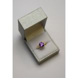 A square cut amethyst ring having small eight cut diamonds around,