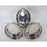 A set of three EPNS oval entree dishes and covers with twin handles and beaded rims