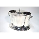 A silver plated two bottle wine cooler with lid for central ice compartment