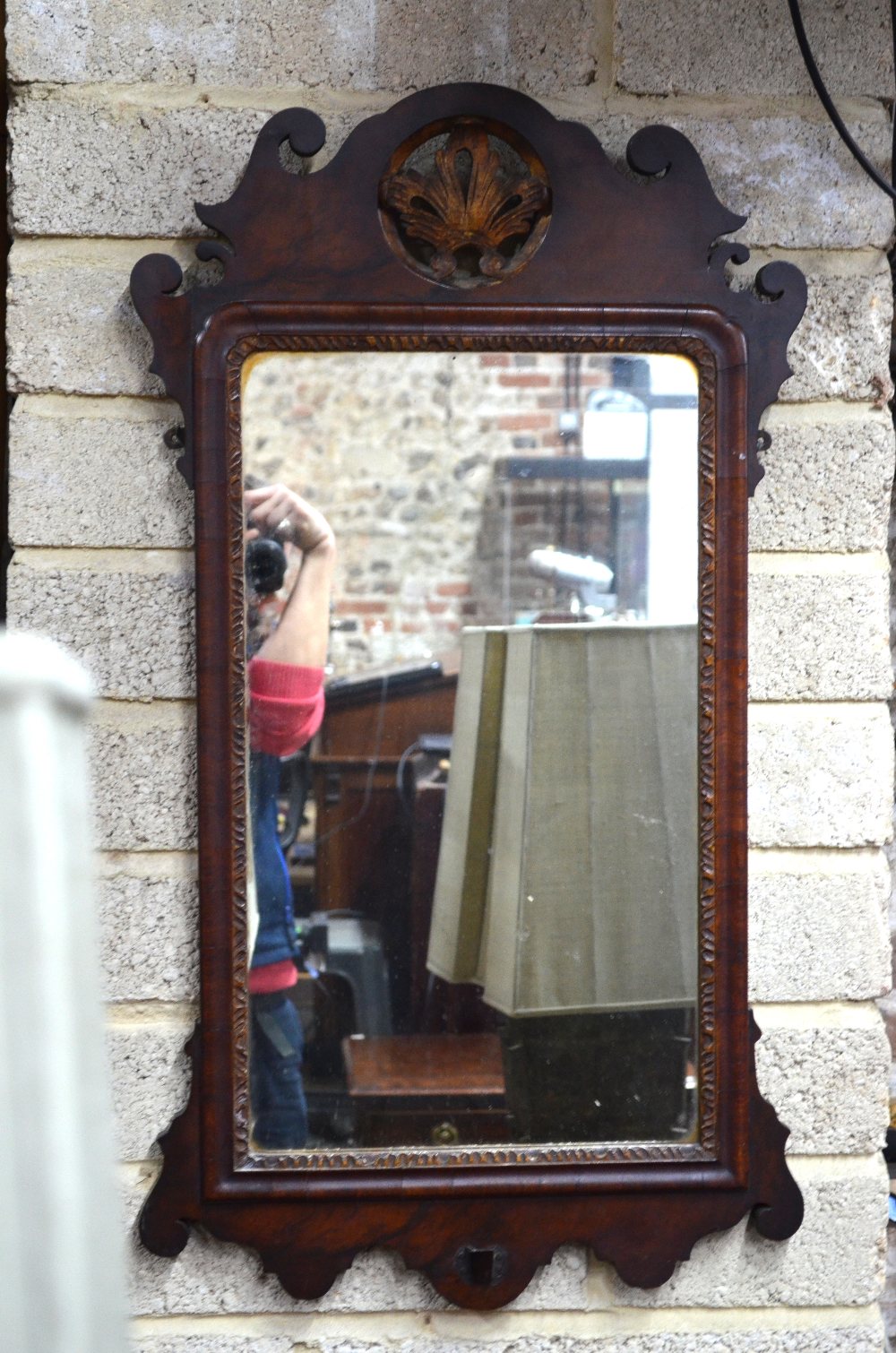 A 19th century parcel gilt fret cut mahogany mirror, centred with a gilt detail crest,