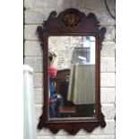A 19th century parcel gilt fret cut mahogany mirror, centred with a gilt detail crest,