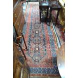 An antique Persian Hamadan runner, the stylised floral design on blue ground,