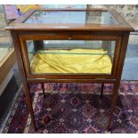 A cross-banded mahogany vitrine table, raised on square tapering legs,