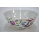 A Chinese famille rose bowl, decorated with a dragon and phoenix among a floral design,