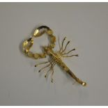 A yellow metal set brooch in the form of a scorpion, the thorax and pedipalps set with opals,