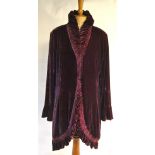 A deep damson velvet evening coat with ruched collar and frill to edge and hem, with flared cuffs,