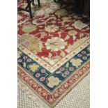 A handmade Agra carpet, the stylised floral deign on coral ground,