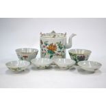 A Chinese famille rose part-service comprising: a teapot and cover; two bowls and four covers;