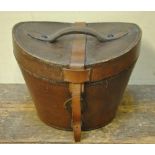 A vintage tan leather hat box lined in padded puce silk,