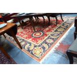 A handmade Agra carpet, the stylised floral design in shades of red and turquoise design,