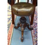 A Victorian carved and moulded walnut tripod revolving piano stool,