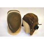 A vintage flying hat, a military tin hat, an HMS Dolphin naval cap, a fencing face guard,