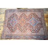 An antique Persian Shiraz rug, very worn overall,