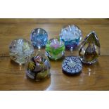 Seven glass paperweights including Isle of Wight and Mdina and a Twist weight with applied glass