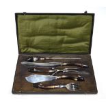 A cased electroplated three piece carving set and a pair of fish servers with horn handles,