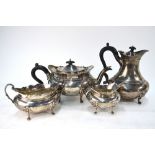 A heavy quality oval silver four-piece tea service with flared rims, scroll handles and pad feet,