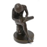 A classical style brown bronze cast seated young man,