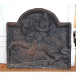 An antique sand-cast iron arched fire-back, embossed with relief equestrian portrait of George I,