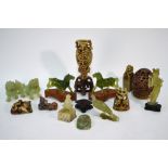 A group of fourteen Chinese soapstone or other carvings, including: a pair of Buddhistic lions,