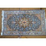 A Persian Hereke part silk rug, blue ground,