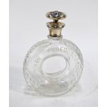 A novelty cut glass whisky decanter in the form of a tyre, engraved 'When Tyred, Scotch',