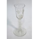 An early 19th century ale glass, the ogee bowl etched with hop and barley decoration,