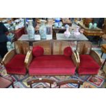 An Art Deco period walnut framed three-piece bergere suite with red velveteen seats,