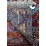 An old Anatolian Kuba triple pole design rug, on blue ground,