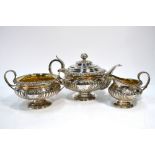 A George IV Regency-style Scottish silver three-piece tea service of compressed melon form,