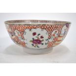 A famille rose bowl decorated with Manchu/Chinese figures at leisure and panels of floral designs,