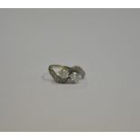 A diamond set two stone cross over ring, in claw setting, with eight cut diamonds on shoulders,