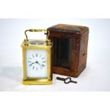 A brass carriage clock, the single train movement with white enamelled dial, in travel case,