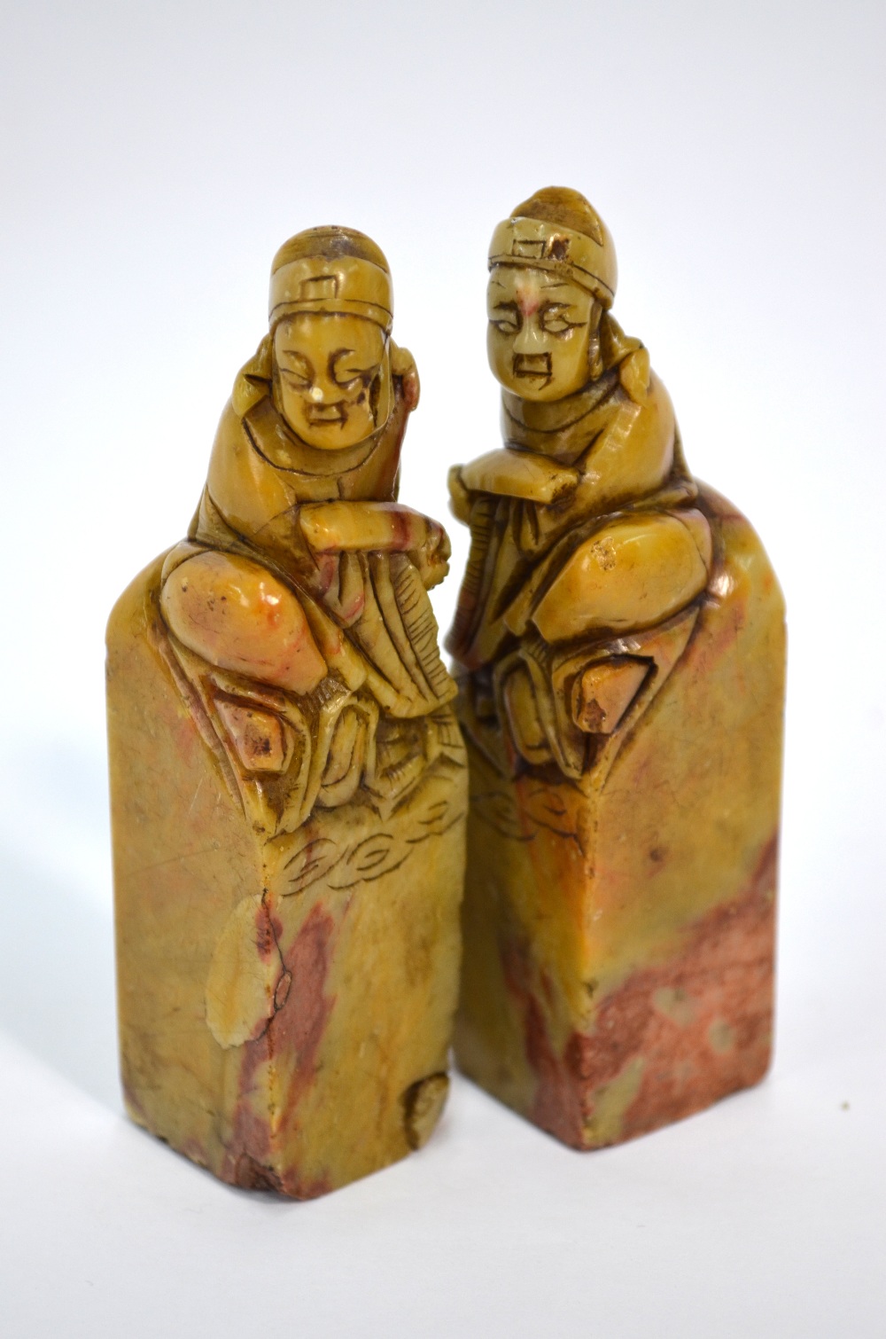 A pair of soapstone seals, each one designed with seated scholar finial; 10 cm high.