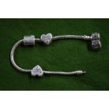 A child's Pandora bracelet with three charms, 2 x daughter and one I've been good letter to Santa,