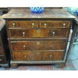 A late 17th century country jointed feather-banded walnut chest of two short over three long