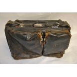 A vintage gentleman's leather flight holdall with British Airways and other labels,