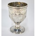 A Victorian silver stemmed Christening cup with Gothic style embossed and chased floral decoration,