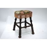 An antique turned fruitwood stool,