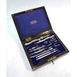 A vintage rosewood cased set of nickel and steel drawing instruments, two with turned bone handles,
