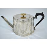 A Victorian silver teapot of tapering ogee form with engraved decoration,