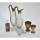 Two small silver trophy cups, a pressed glass scent bottle in embossed and pierced silver sleeve,