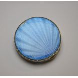 A circular silver power compact having pale blue guilloche enamel lid in sunburst design