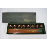 A boxed set of eight Taylor-Rolfe lignum vitae Billiard Bowls,