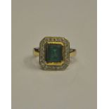 An emerald and diamond set rectangular cluster ring,