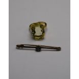 An oval citrine ring in 18ct yellow gold four claw setting to/w bar brooch set with small blue