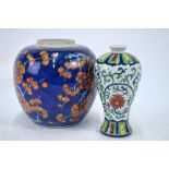 A clobbered blue and white ginger jar decorated with prunus,