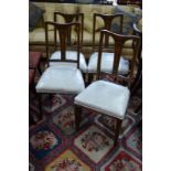 A set of four Edwardian inlaid mahogany dining chairs,