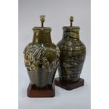 Two olive green monochrome vases decorated in the Chinese style, both mounted for electricity,