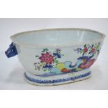 A Chinese famille rose tureen with blue animal head handles, decorated with floral and leaf designs,