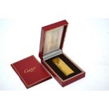 A Cartier of Paris gilt metal cigarette lighter, little used, in original box,